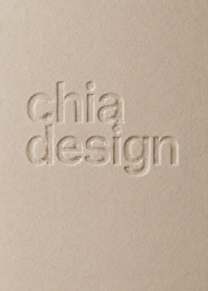 Debossed chia design wordmark on textured tan paper.